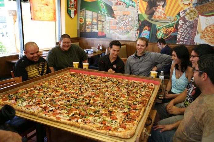 The Largest Pizza Commercially Available In The World 696x464 